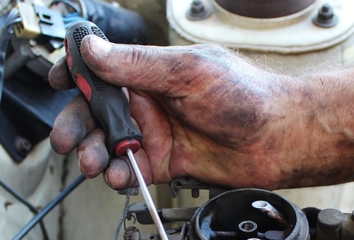 Technician working on vehicle components